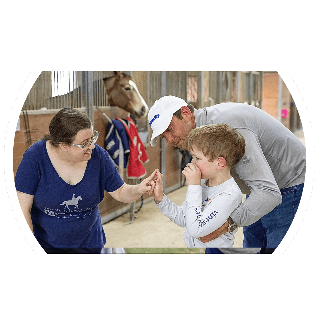 A man and woman with two children in front of a horse.