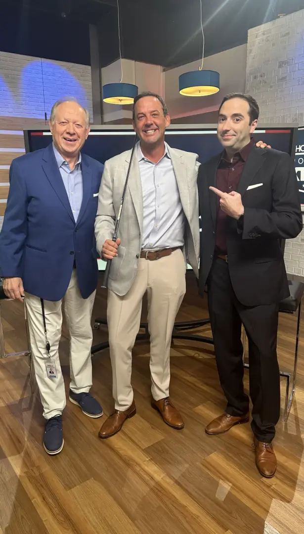 Three men in suits and ties posing for a picture.